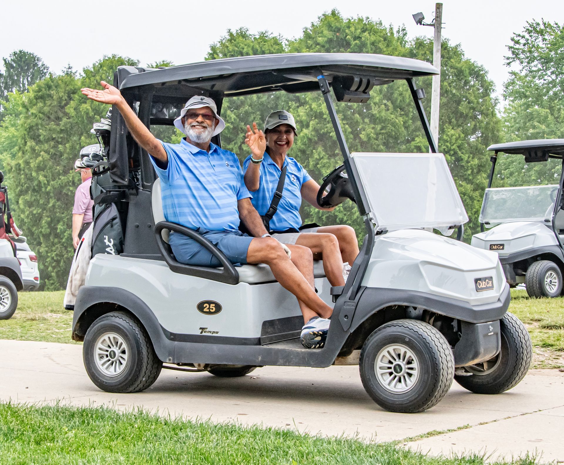 Four men are posing for a picture on a golf course