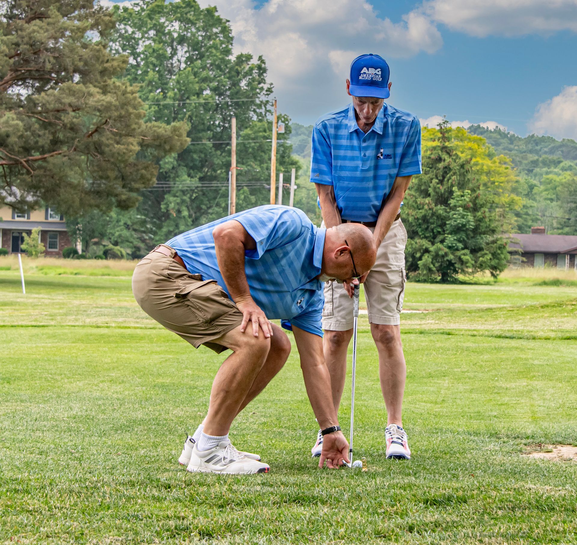 A group of people posing for a picture on a golf course