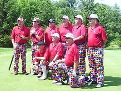 A group of men are posing for a picture on a golf course.
