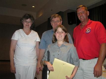 A blind young lady receiving a scholarship