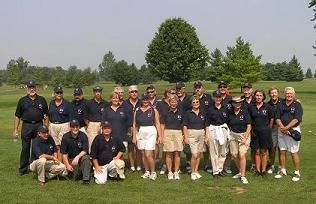 Team USA posing for a picture on the golf course in their matching blue polos