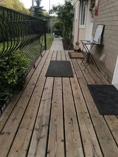 A wooden deck with a black mat on it
