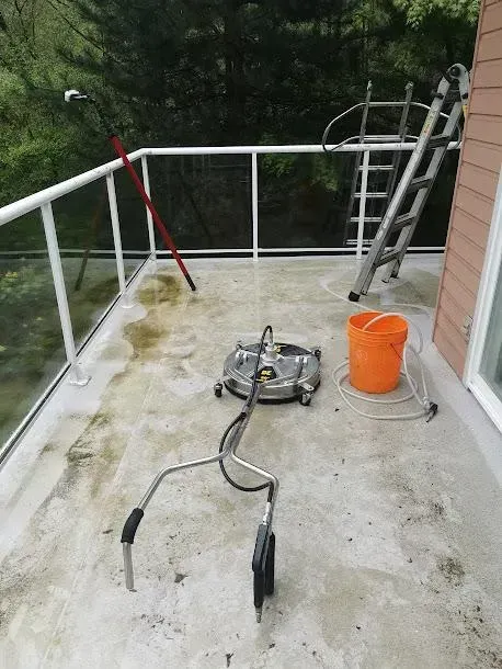 A balcony with a ladder and a bucket on it.