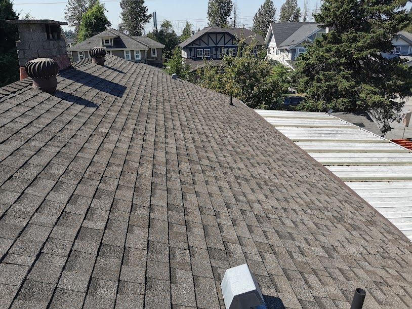 A roof with a lot of shingles and a chimney on it.