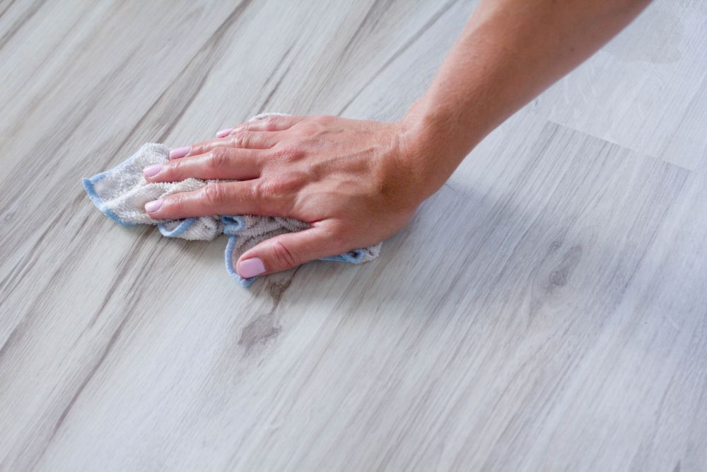 Hand Wiping a Light-coloured Wood Floor — Cairns Local Cleaning Services in Woree, QLD