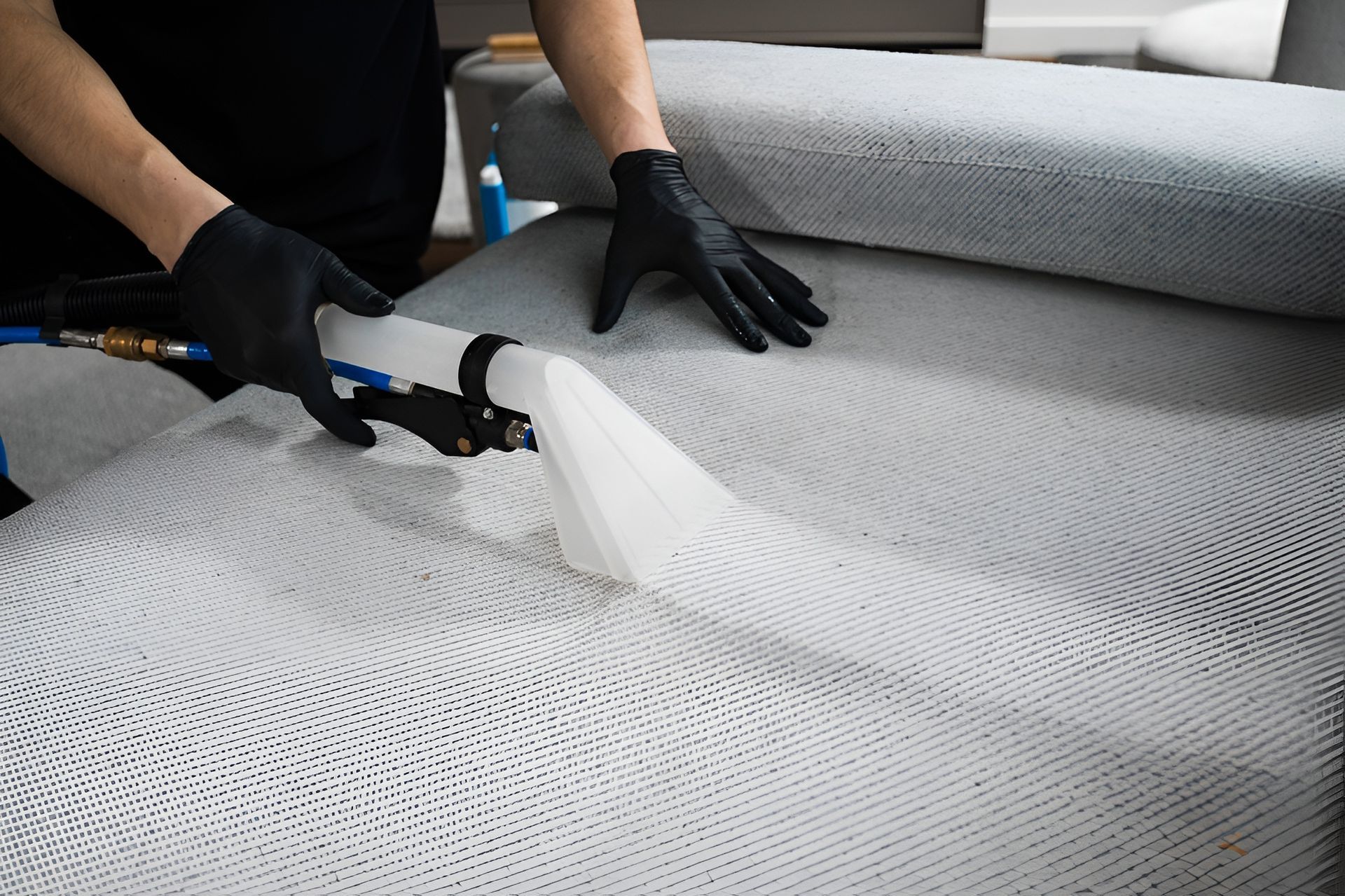 Person in Black Gloves Cleans a Light-coloured Sofa — Cairns Local Cleaning Services in Woree, QLD