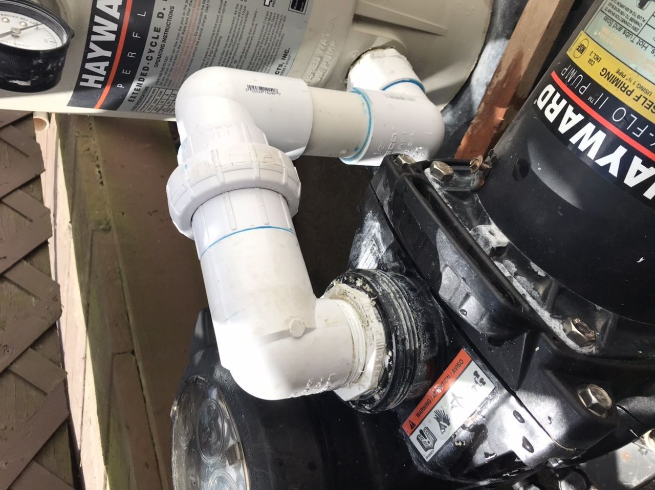 Electrician working on a circuit breaker panel with a screwdriver.