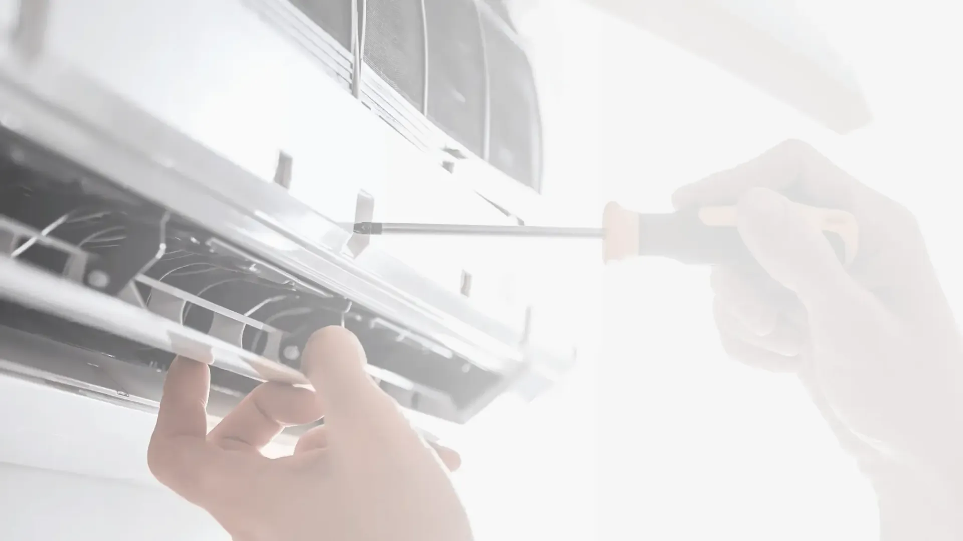 Electrician using a multimeter to test wiring in a control panel.