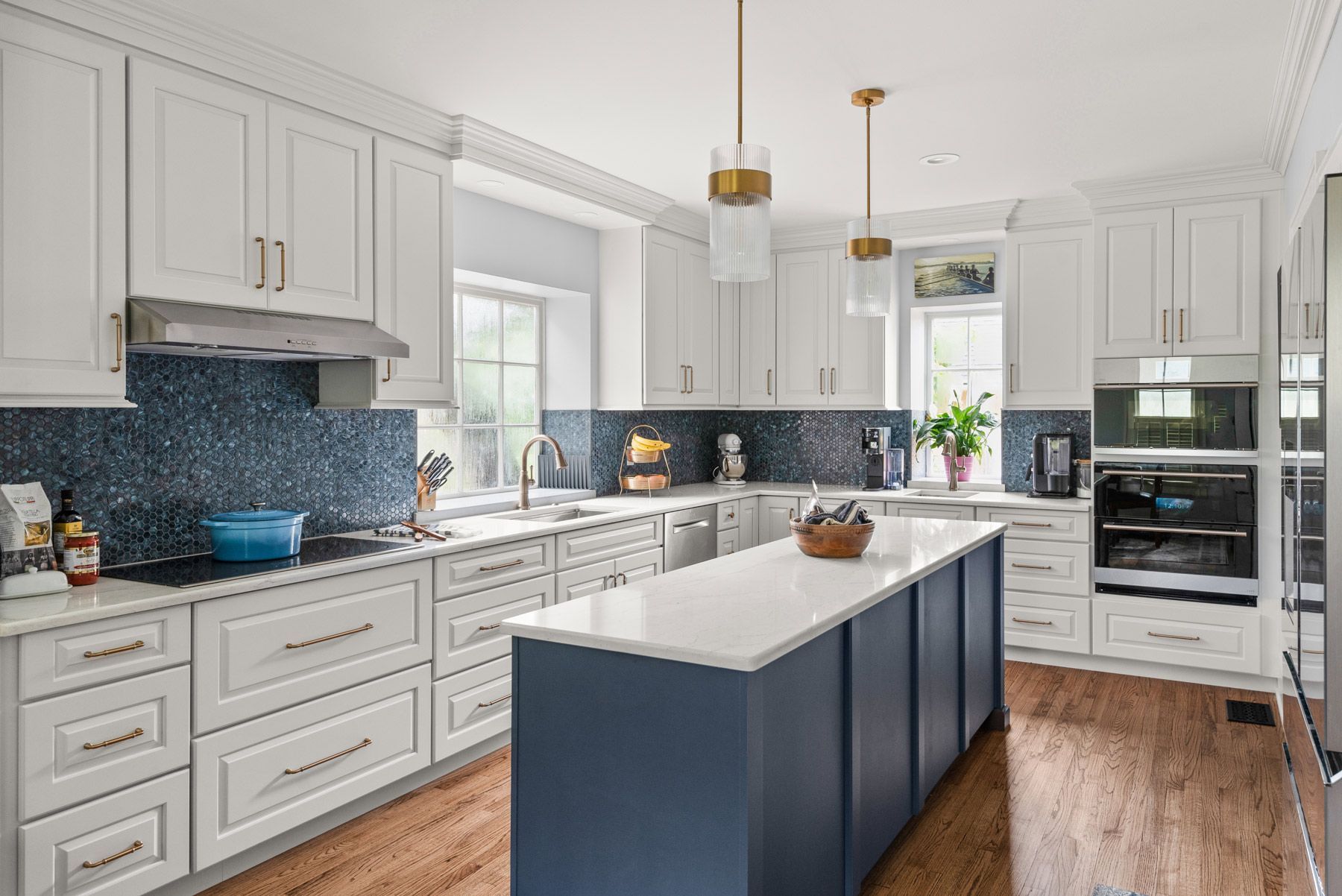 Two beige generators with black panels and cables on a gravel surface near a fence.