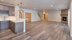 Electrician working on a circuit breaker panel with a screwdriver.