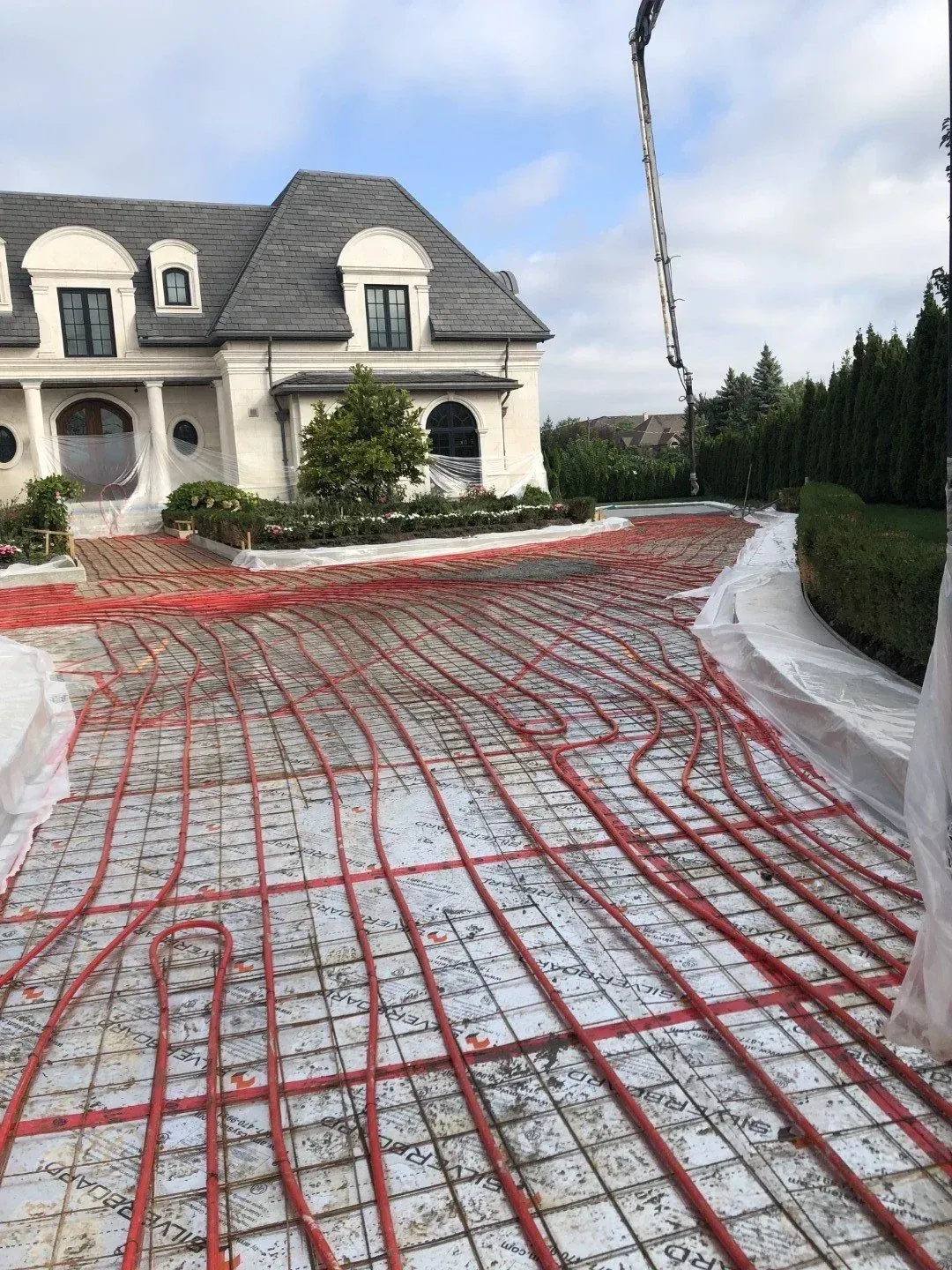 Electrician working on a circuit breaker panel with a screwdriver.
