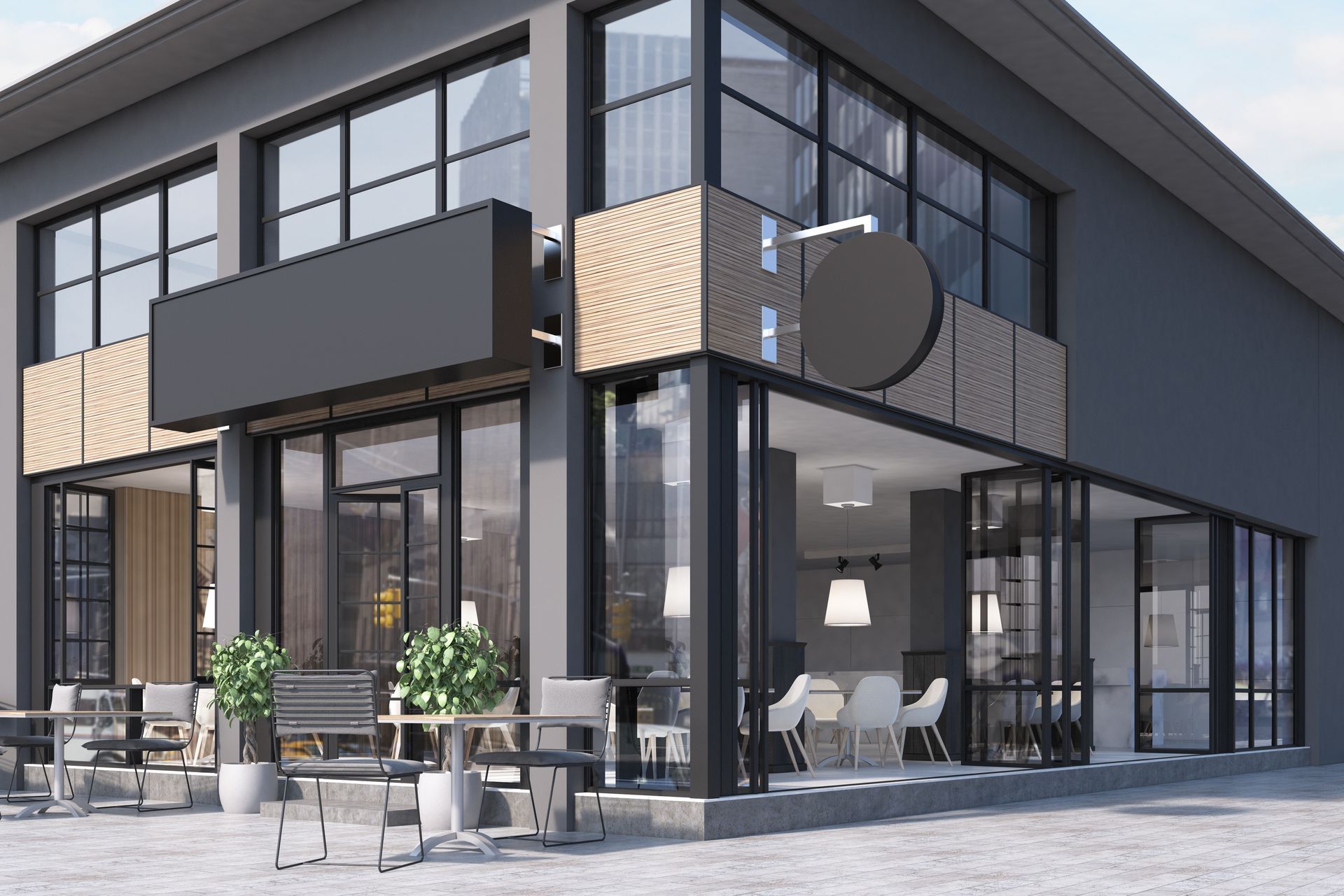 Modern glass-fronted commercial building with outdoor seating, showcasing sleek architecture.