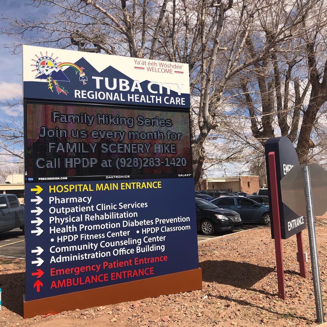 Sign for Tuba City Regional Health Care with directions for hospital services.