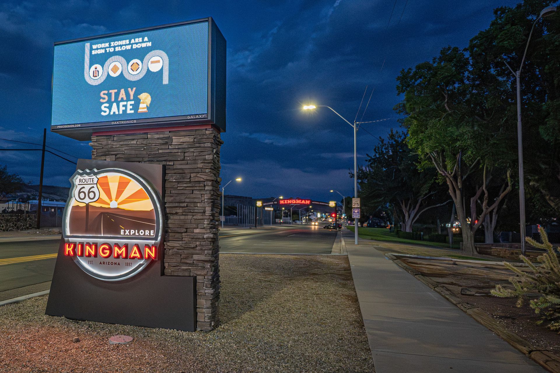 Kingman, Arizona sign at night, with Route 66 logo. 