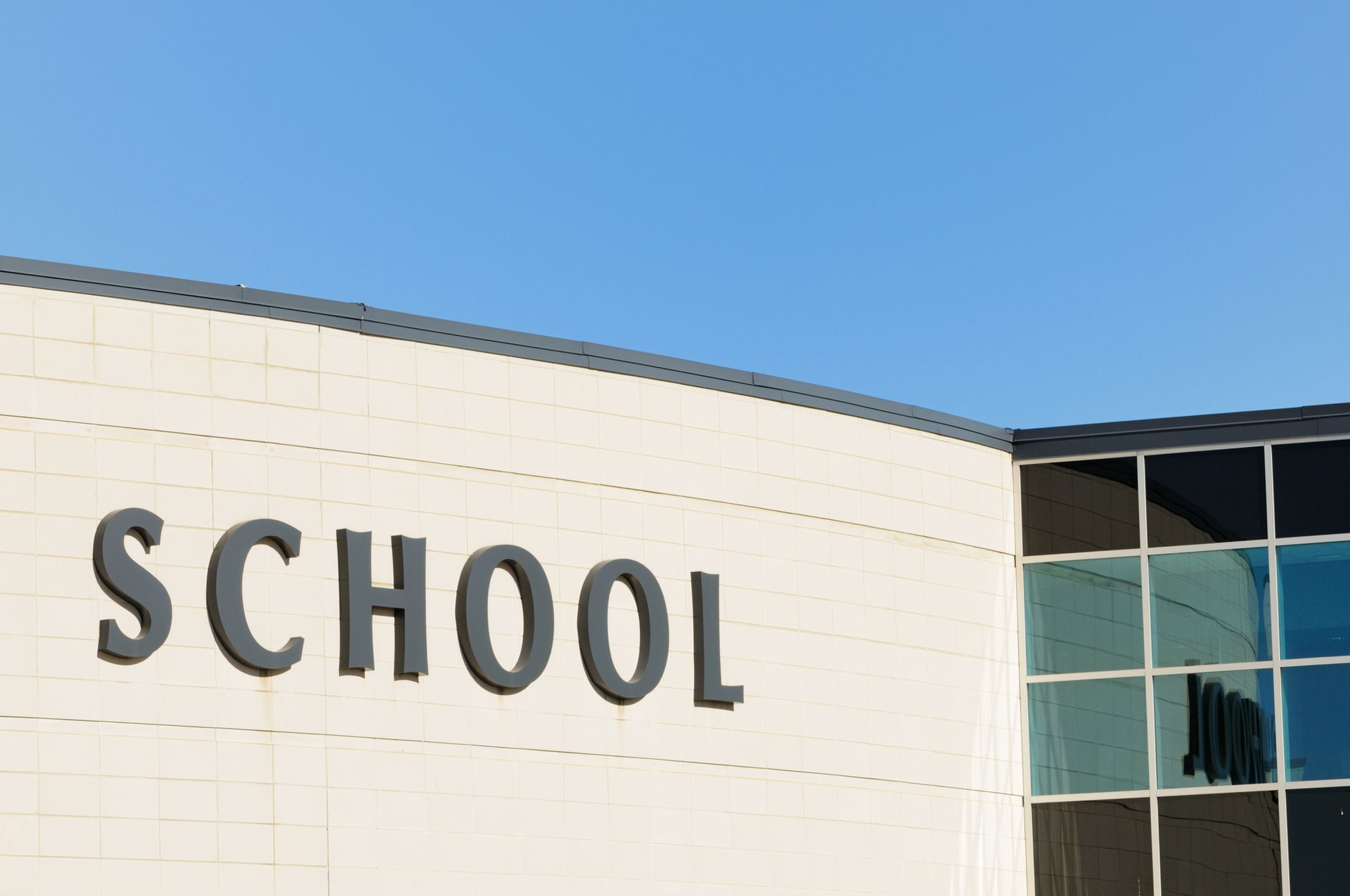 School sign on building.
