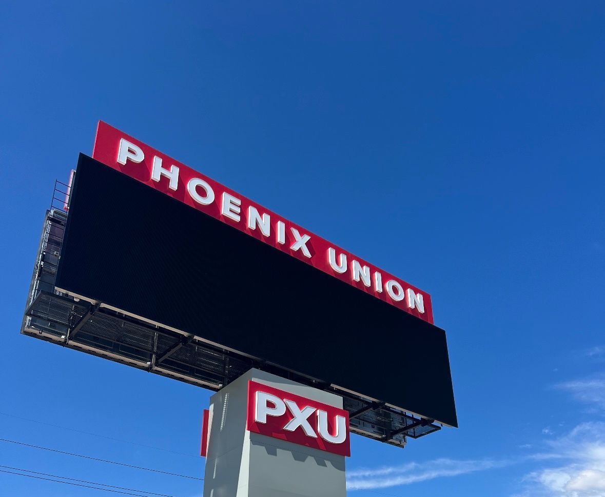 Billboard for Phoenix Union, with a large black display against a blue sky.