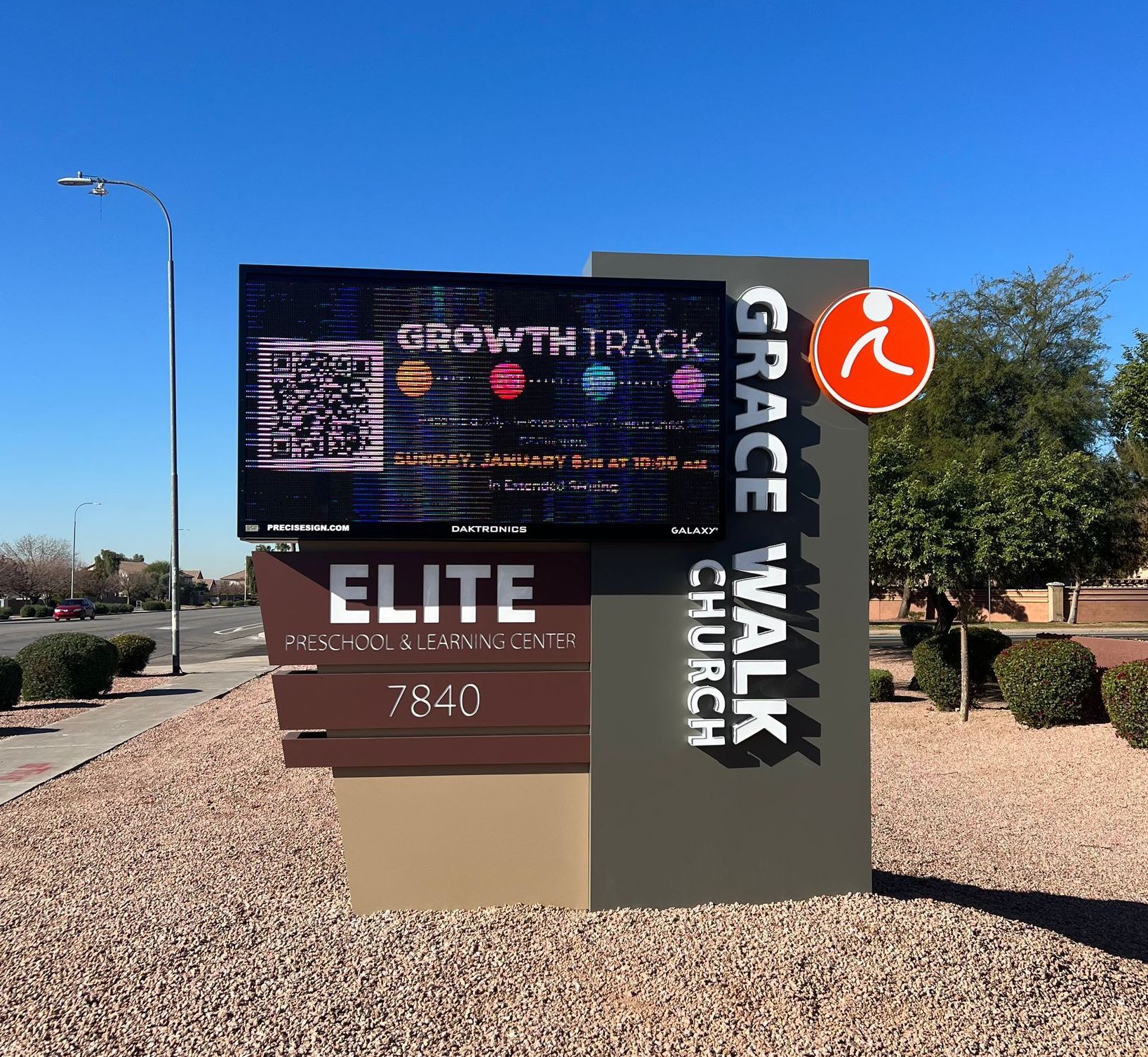 Sign for Grace Walk Church with an LED display, address, and a stylized orange person icon.