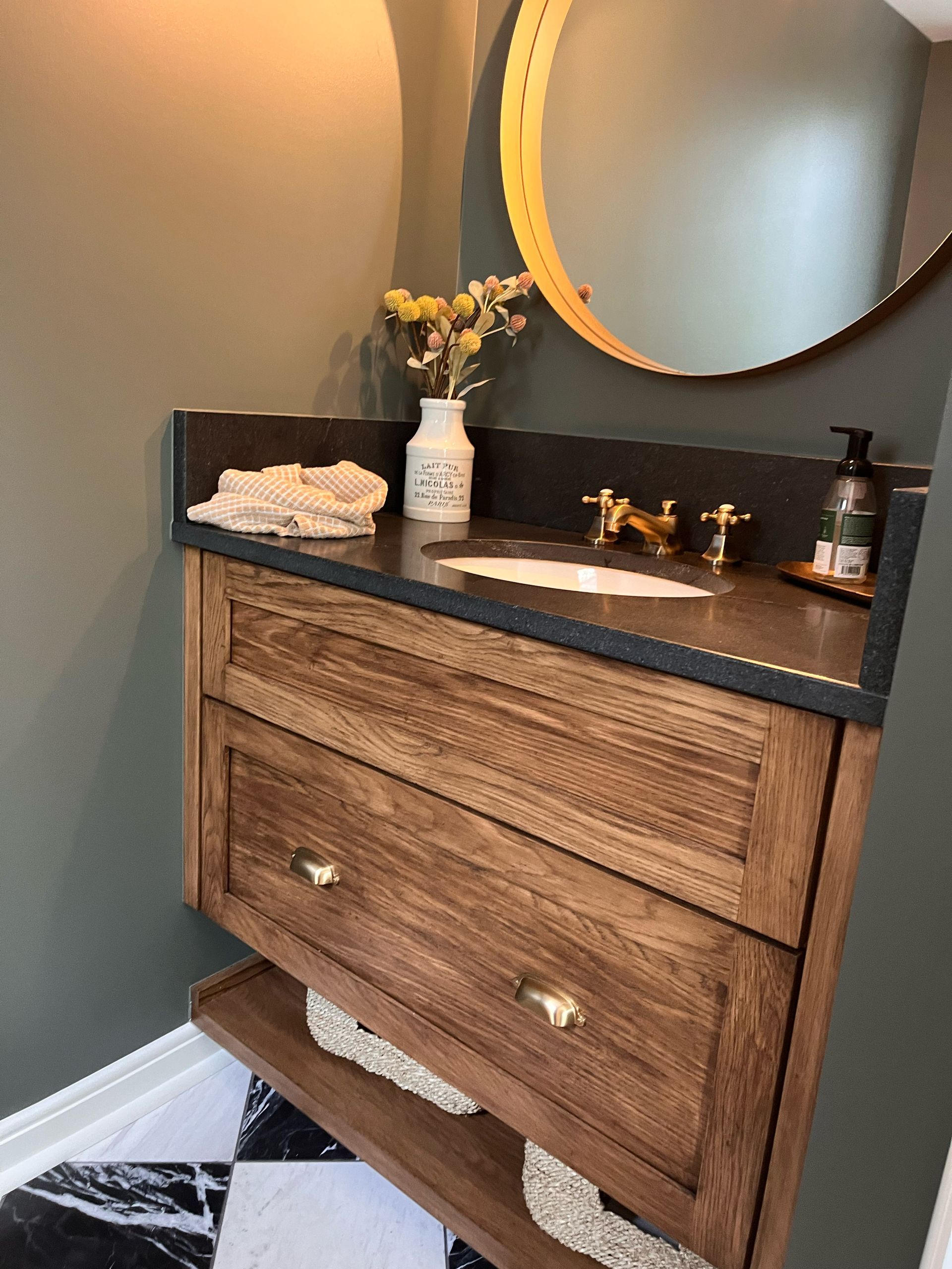 A bathroom with a wooden vanity