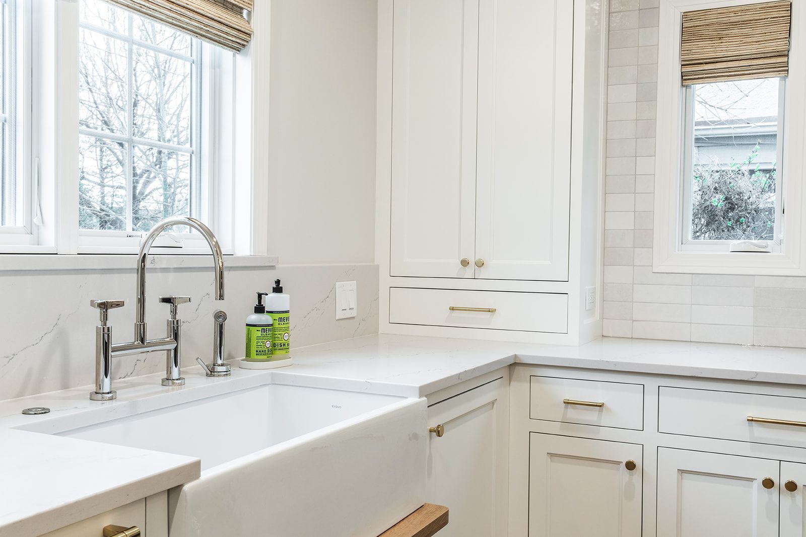 A kitchen with white cabinets 