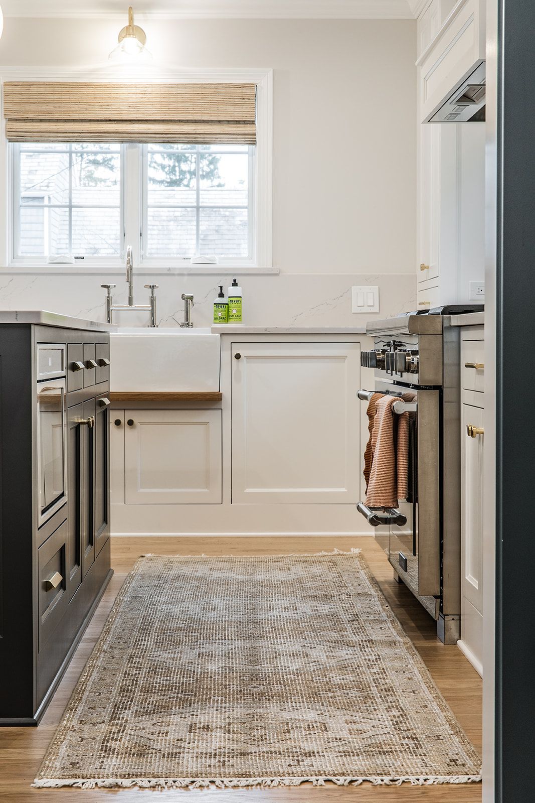 A kitchen with a rug on the floor and a sink
