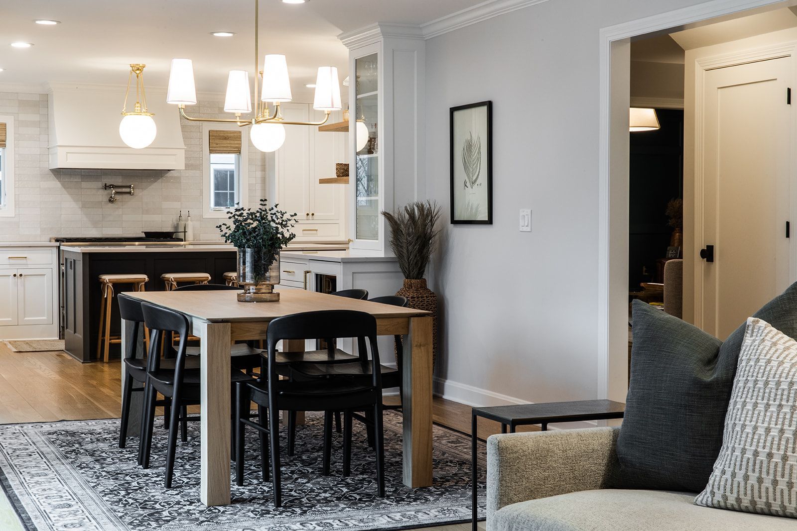 A living room with a dining table and chairs and a chair