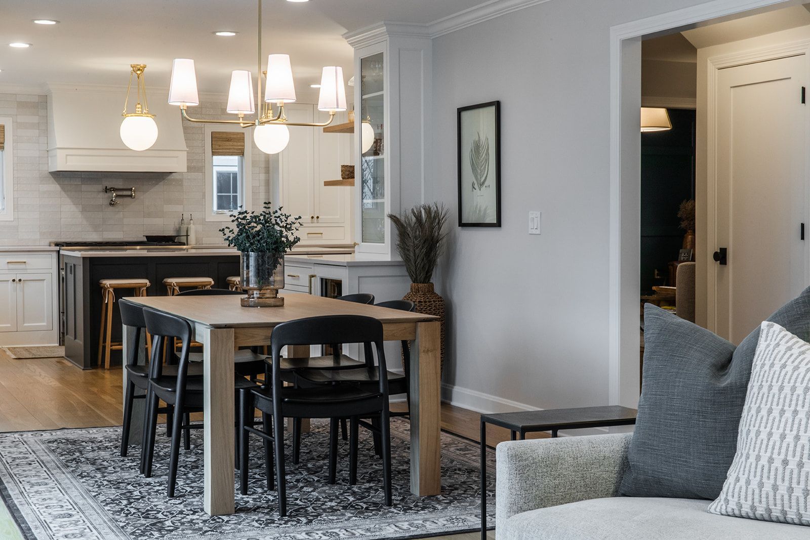 A living room with a dining table and chairs and a rug