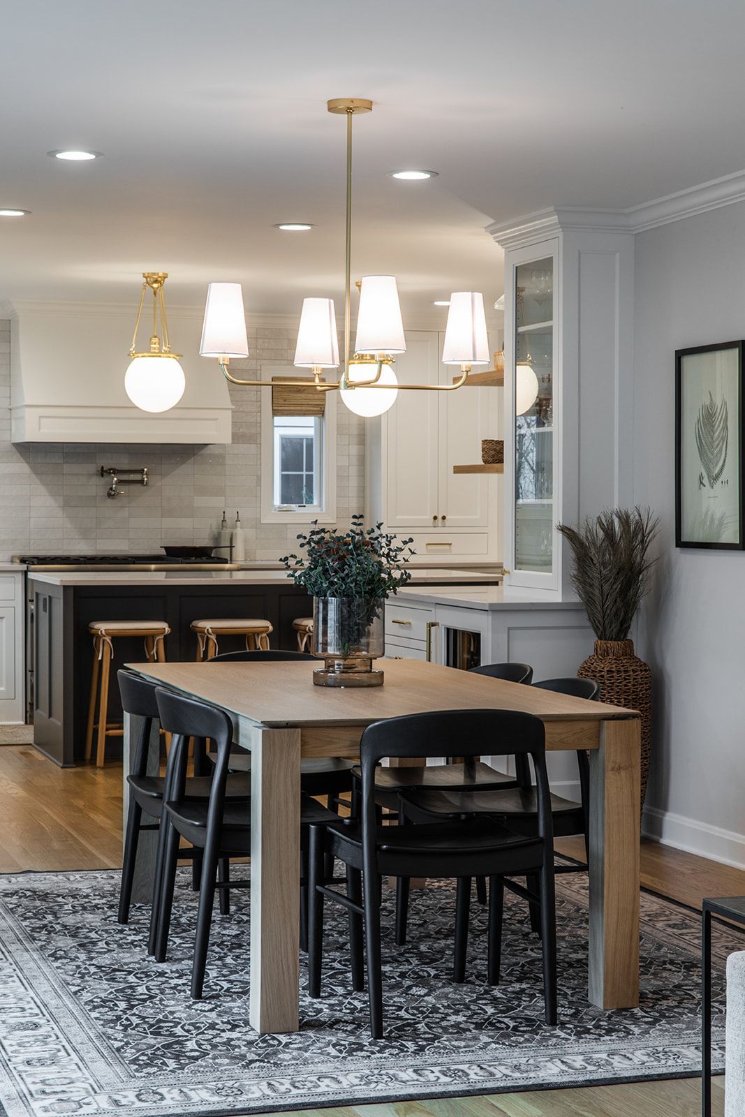 A dining room with a table and chairs and a rug