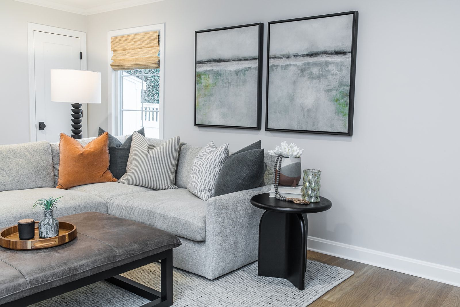 A living room with a two paintings on the wall