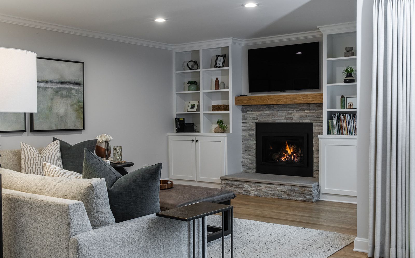 A living room with a fireplace and a flat screen tv