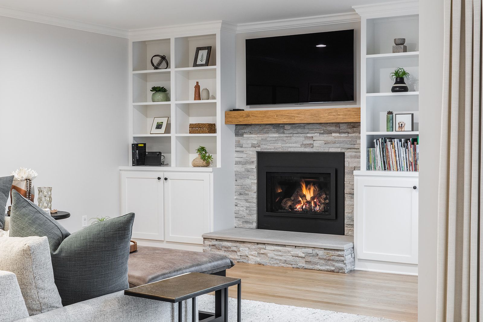 A living room with a fireplace and a flat screen tv