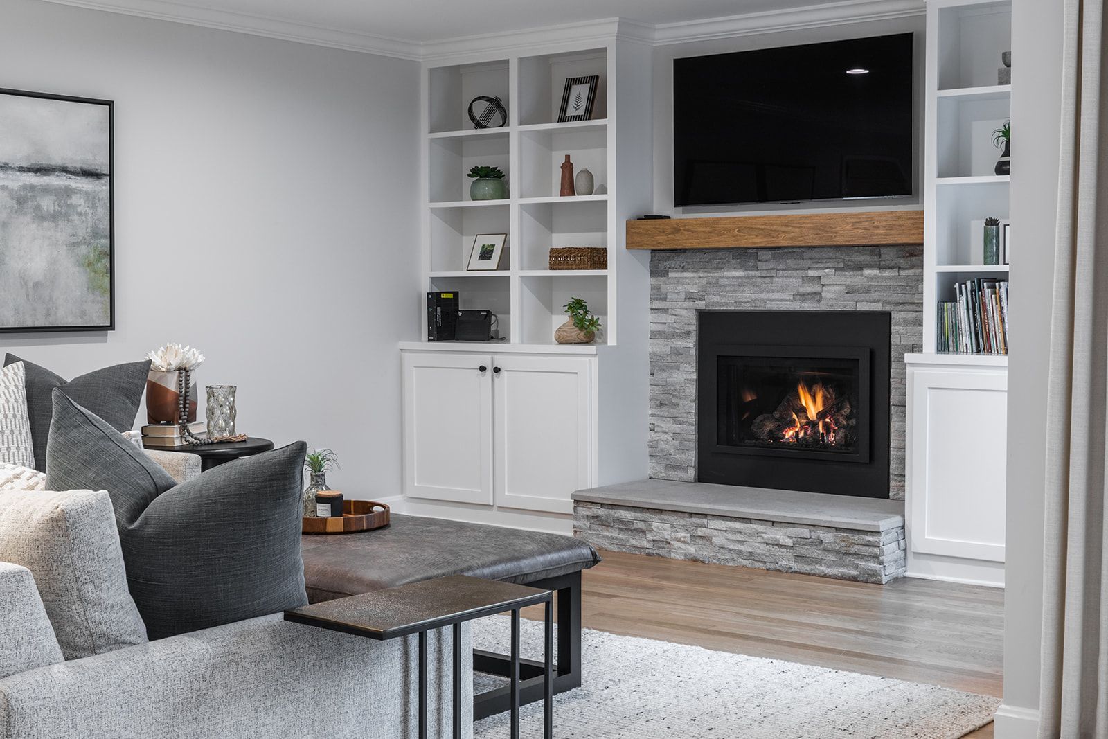 A living room with a fireplace and a flat screen tv