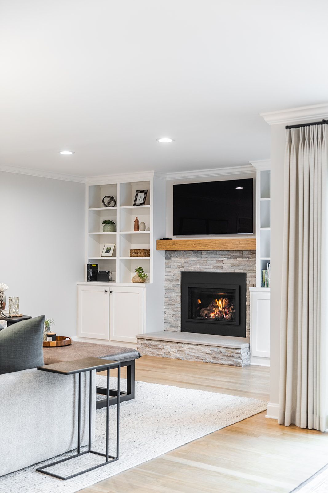 A living room with a fireplace and a flat screen tv