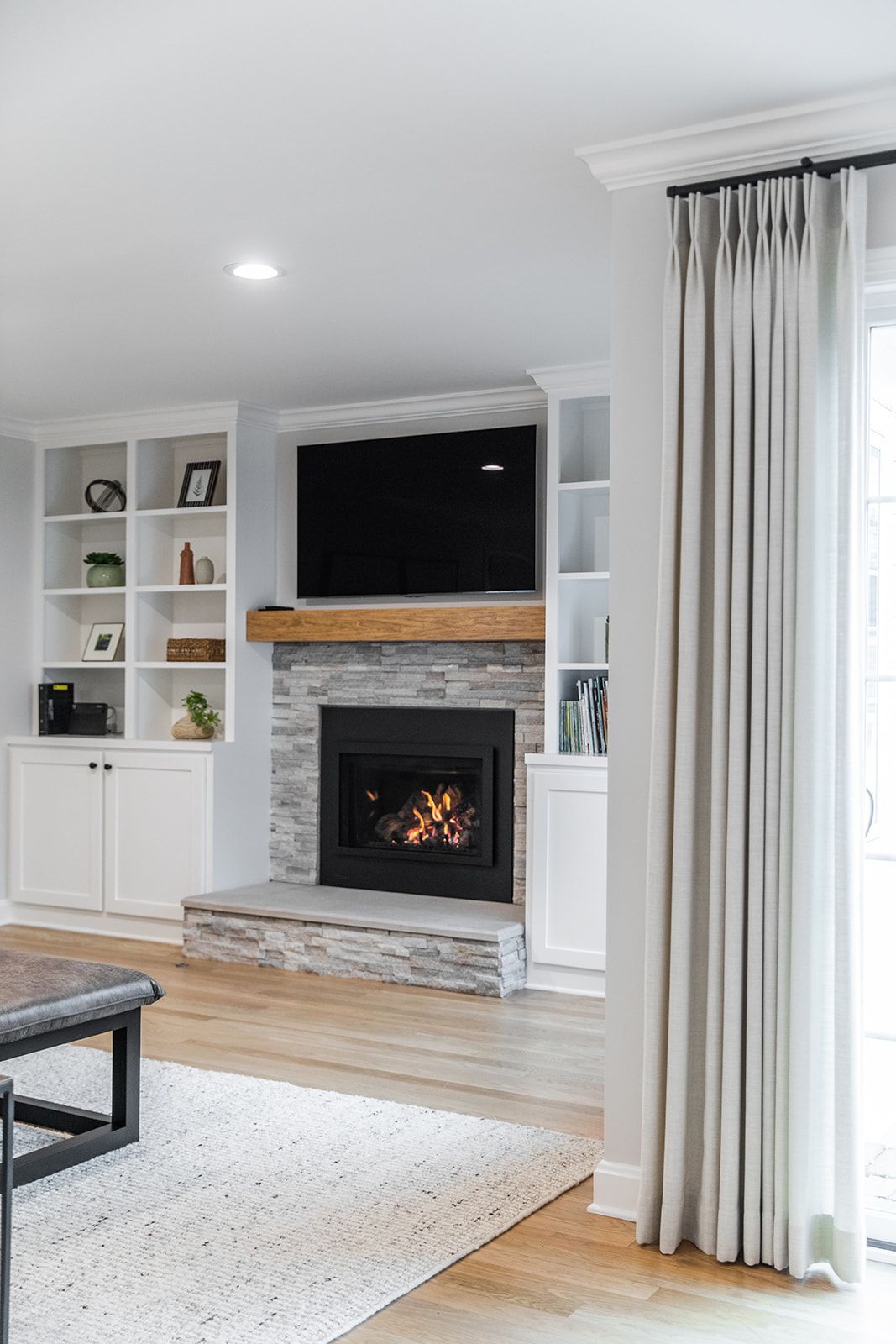 A living room with a fireplace and a flat screen tv.