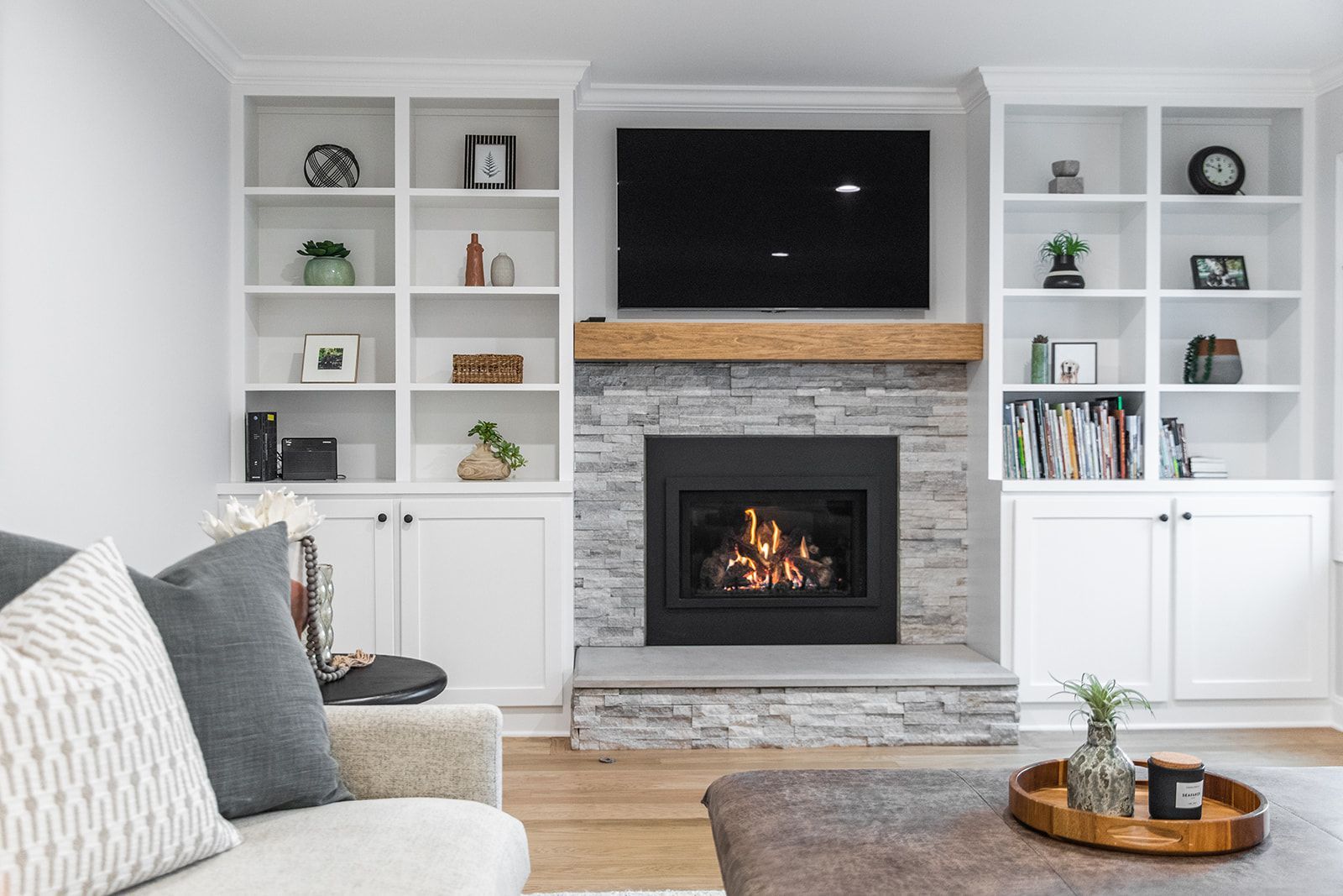 A living room with a fireplace and a flat screen tv