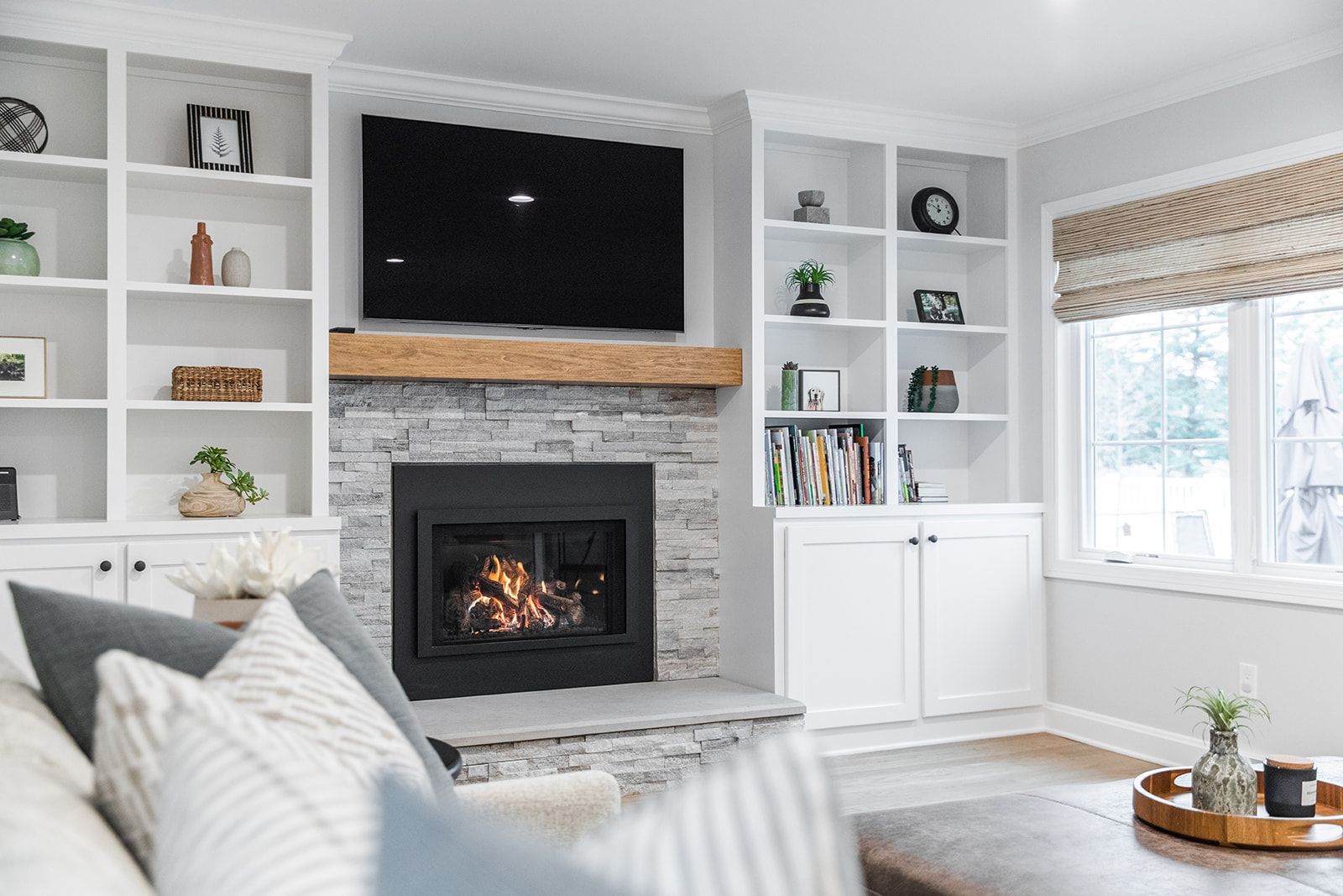 A living room with a fireplace and a flat screen tv