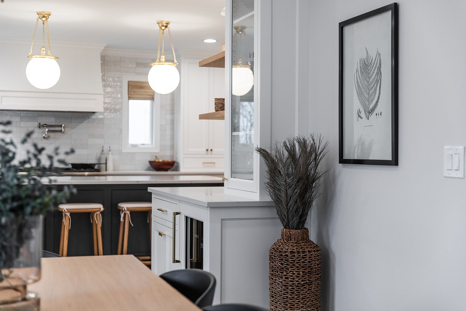 A kitchen with a table and chairs and a picture on the wall
