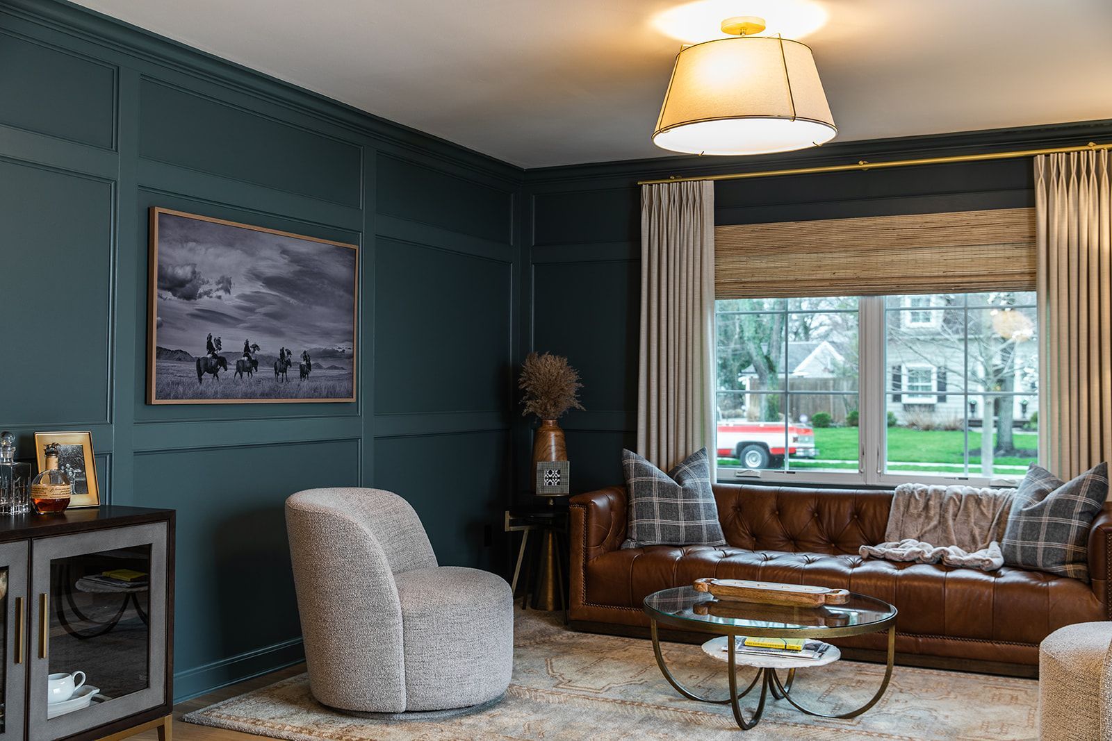 A living room with a table and a large window