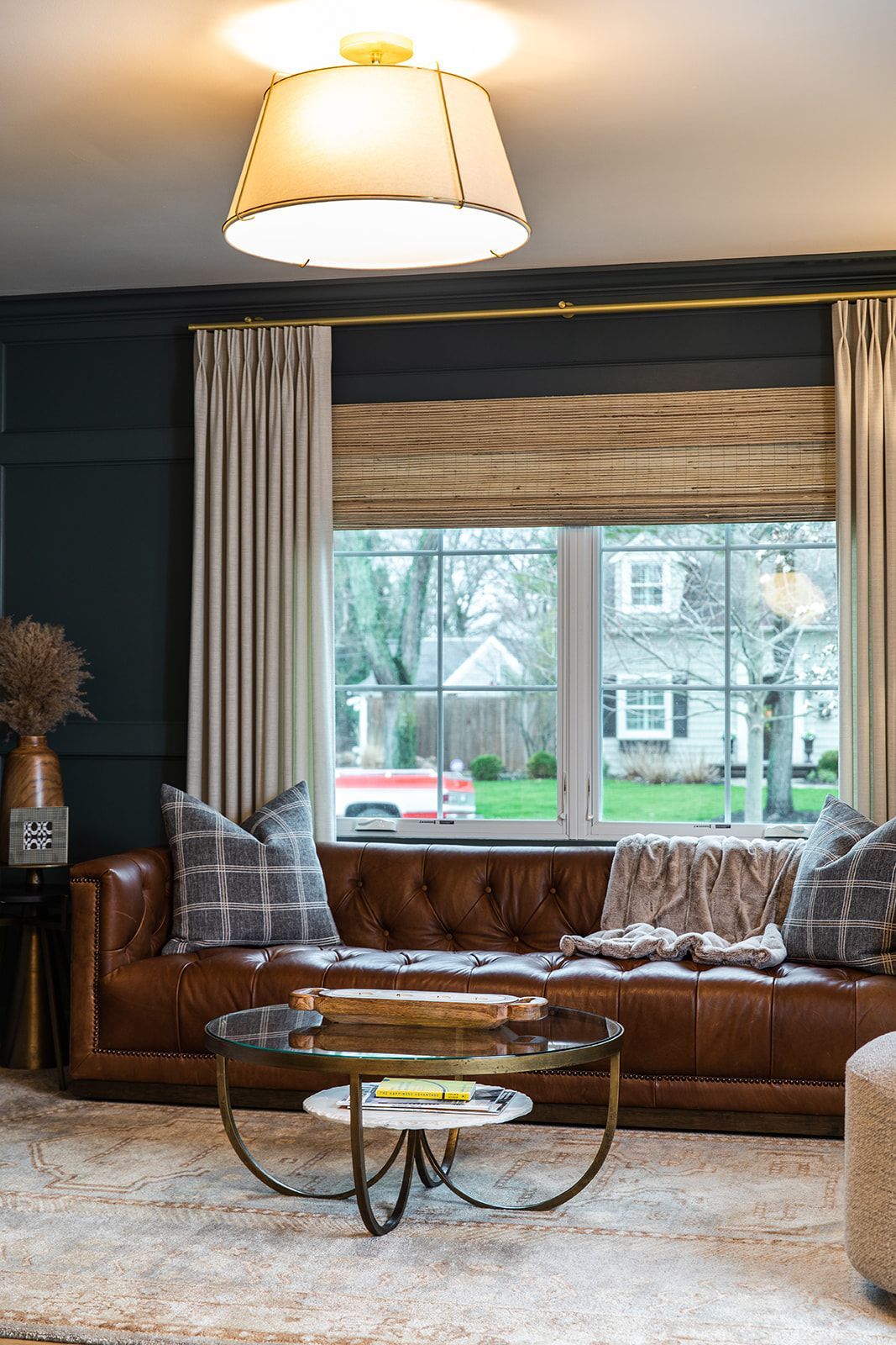 A living room with a brown leather couch