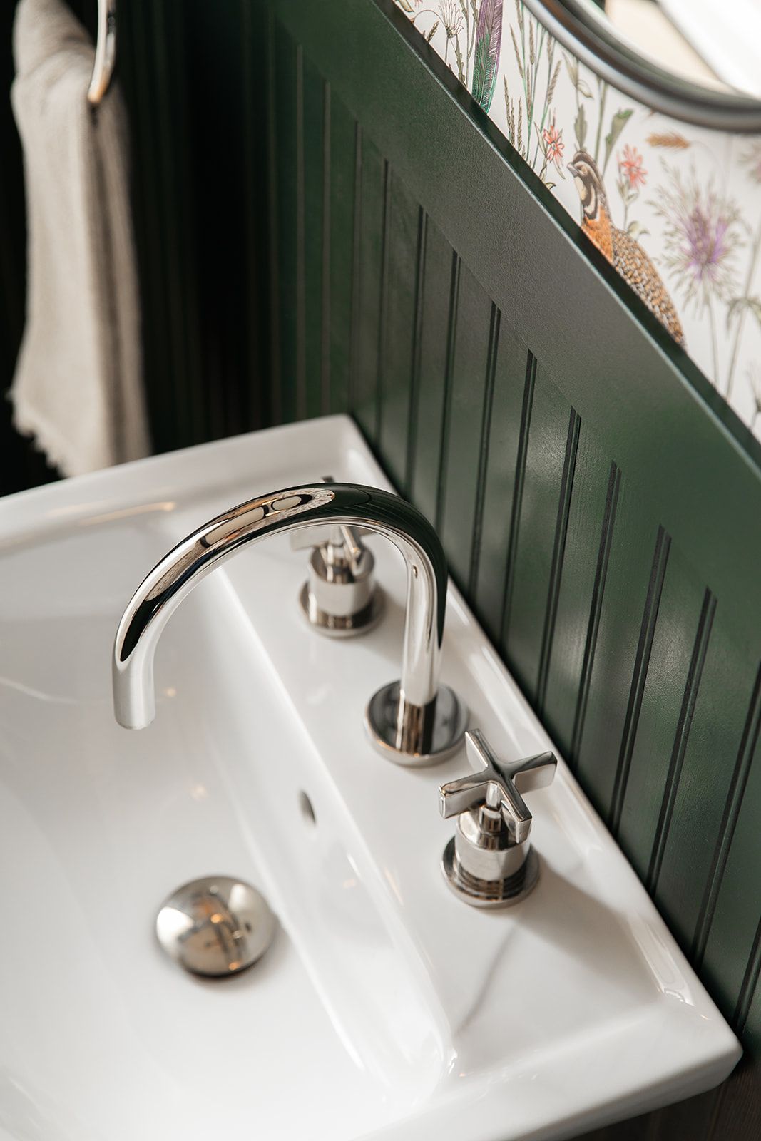 A bathroom sink with a faucet and a mirror.