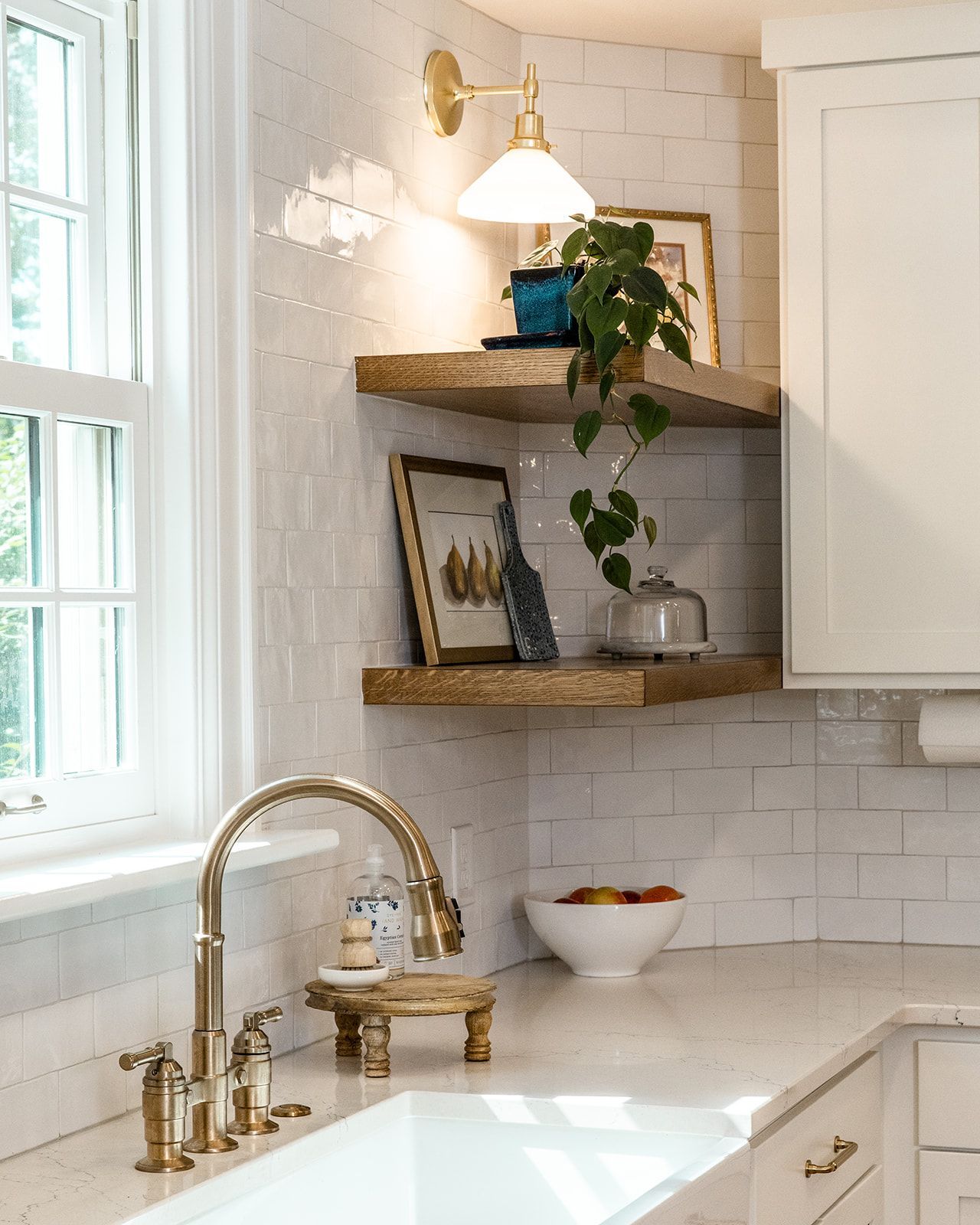 A kitchen with shelves and a window