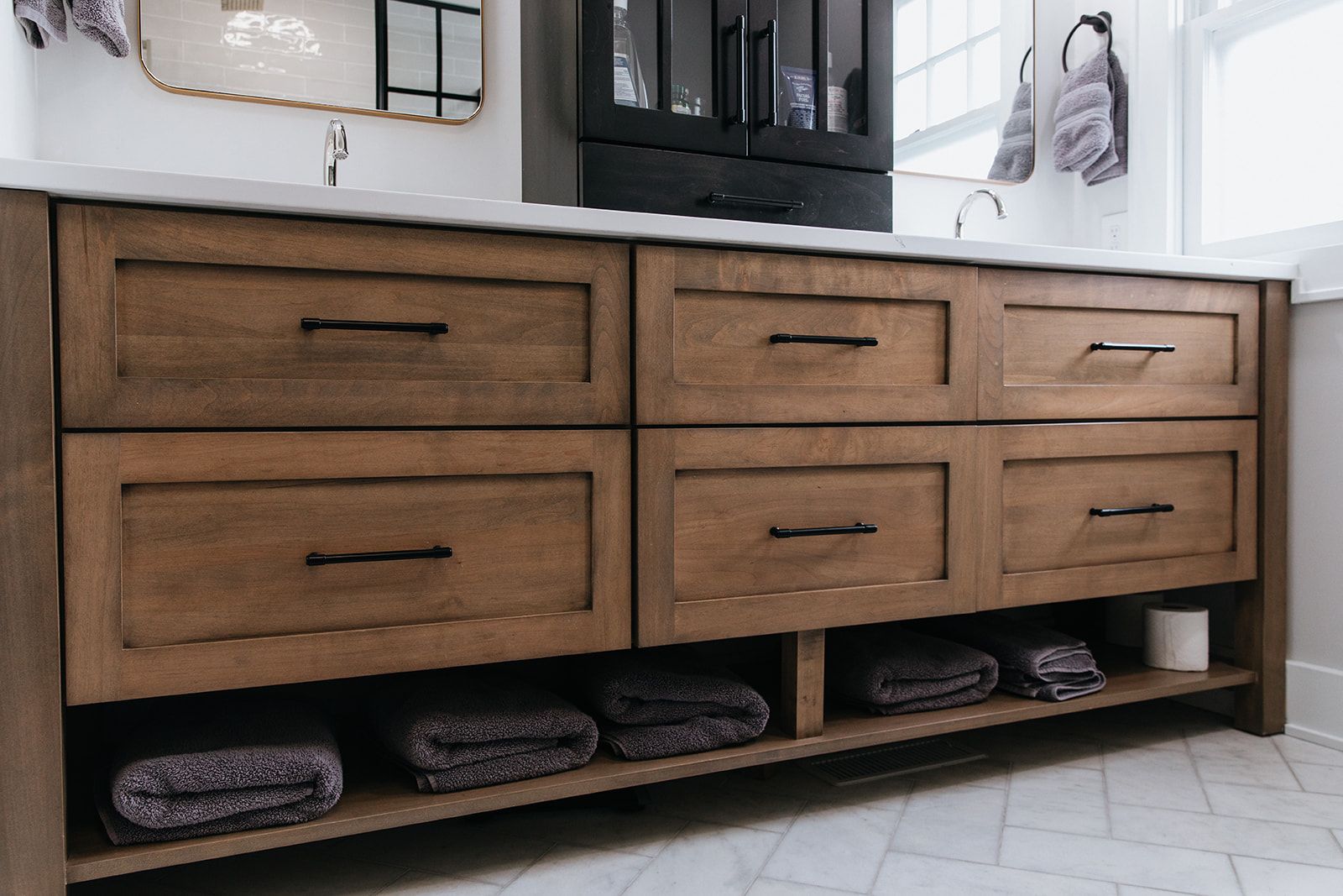 A bathroom vanity with wooden drawers and a sink