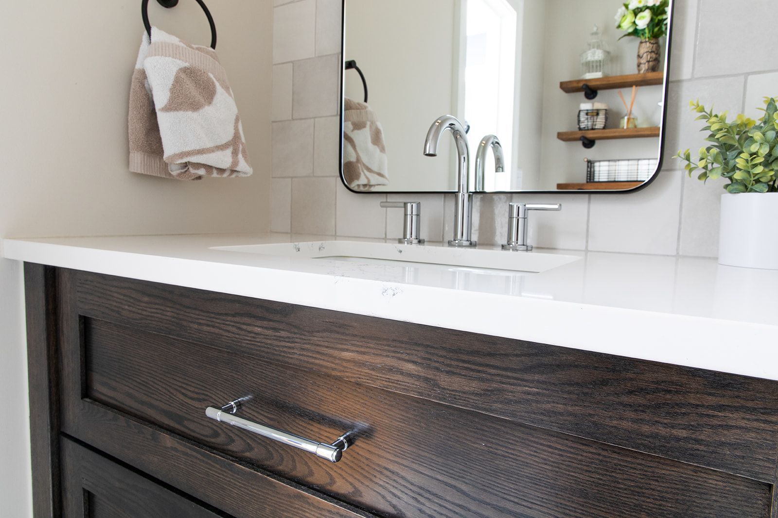 A bathroom with mirror and towel rack