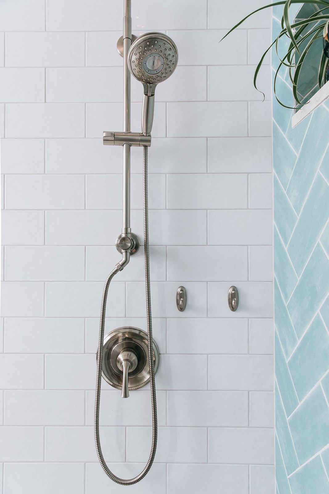 A shower head is hanging from a shower head in a bathroom
