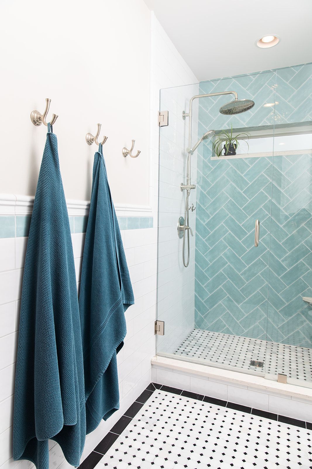 A bathroom with blue tiles and a walk in shower