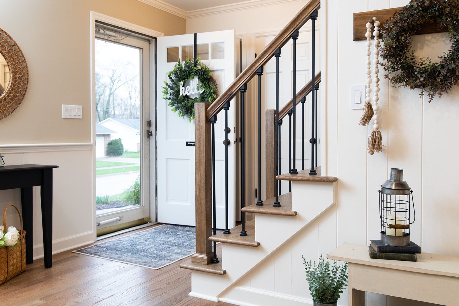 A hallway with stairs leading up to the second floor of a house