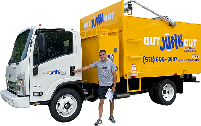 a man stands in front of a yellow out junk out truck