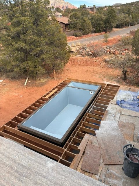 A large swimming pool is being built on top of a wooden deck