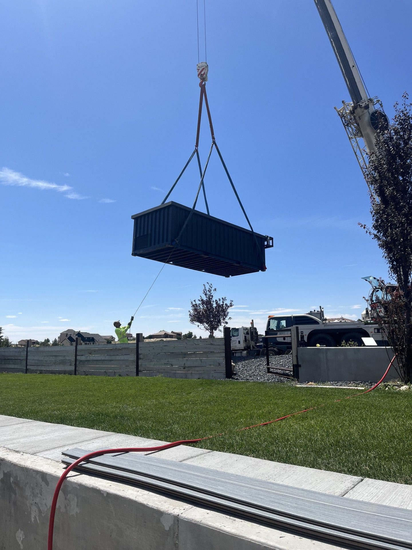 A large container is being lifted by a crane.