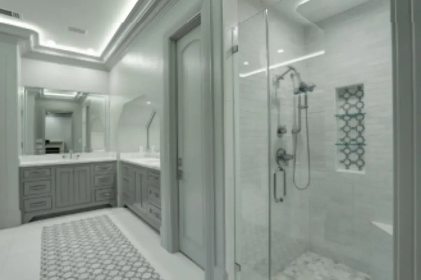 Bathroom with glass shower, gray cabinets, and mosaic tile floor.