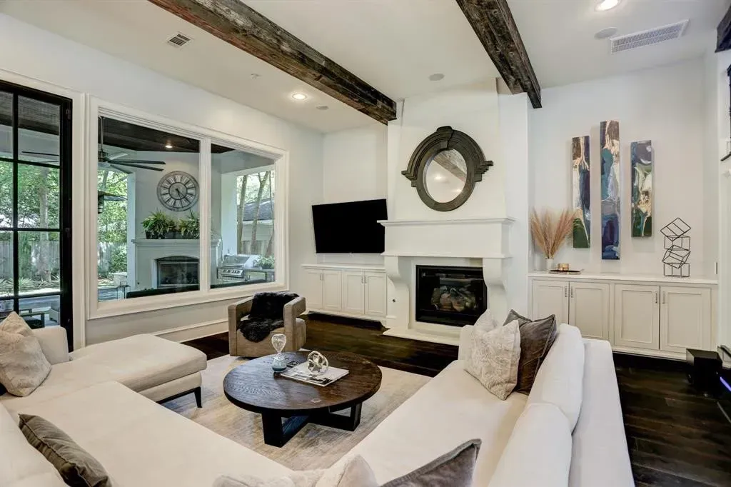 Living room with sectional sofa, fireplace, and large windows.